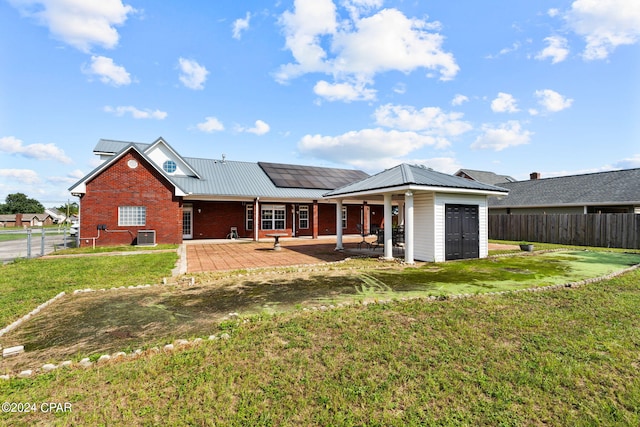 rear view of property featuring a lawn, a patio, and central air condition unit