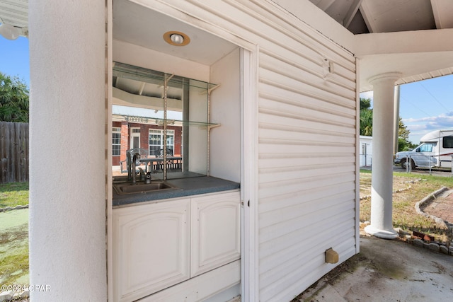 entrance to property featuring a porch and sink