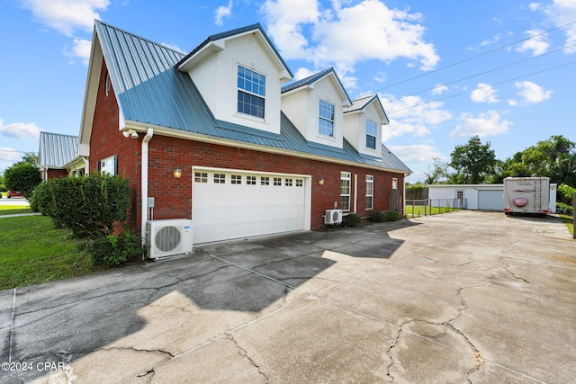 view of home's exterior with a garage and ac unit