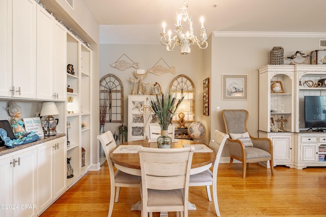 dining space featuring a notable chandelier, light wood-type flooring, and ornamental molding