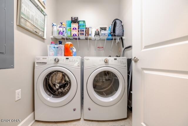 laundry area with washer and clothes dryer and tile patterned floors