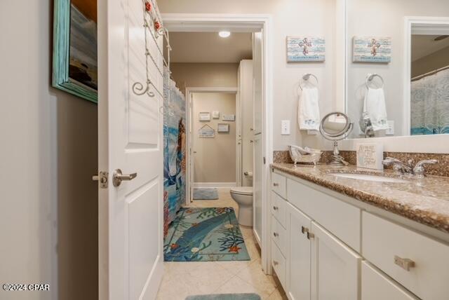 bathroom featuring toilet, vanity, and tile patterned floors