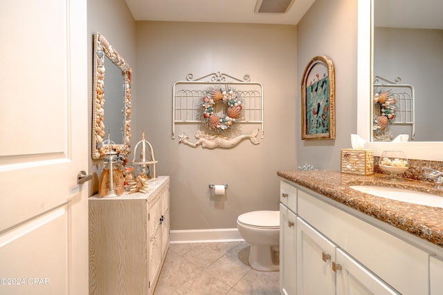 bathroom with tile patterned floors, vanity, and toilet