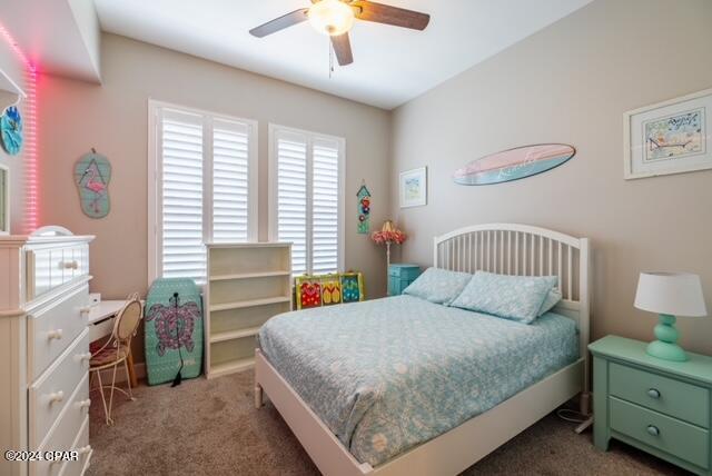 bedroom with dark carpet and ceiling fan