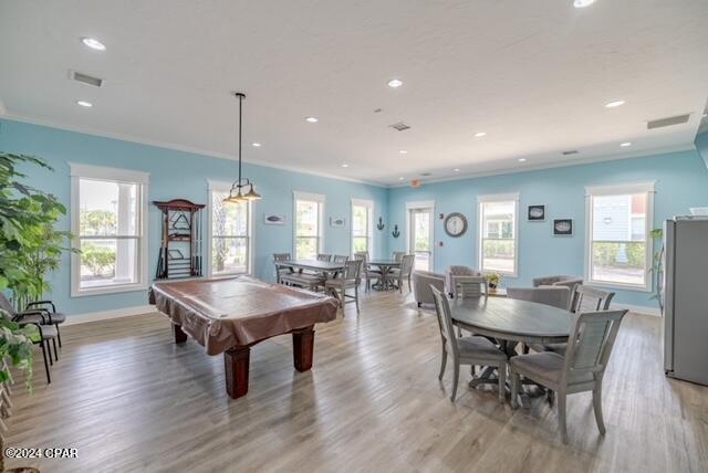 game room with light hardwood / wood-style floors, a healthy amount of sunlight, and billiards