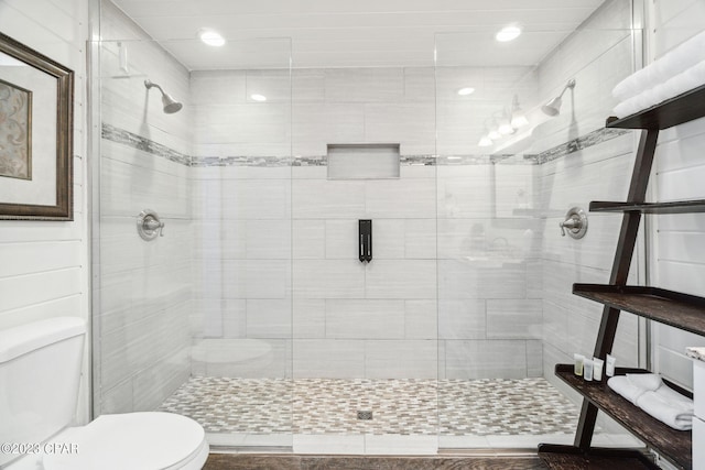 bathroom with toilet and an enclosed shower