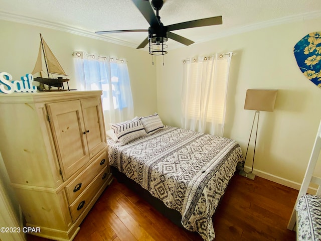 bedroom with a textured ceiling, ceiling fan, crown molding, and dark hardwood / wood-style flooring