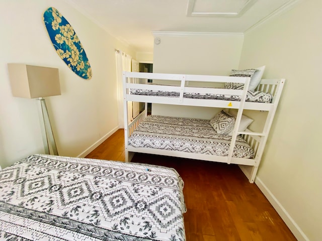 bedroom with wood-type flooring and crown molding