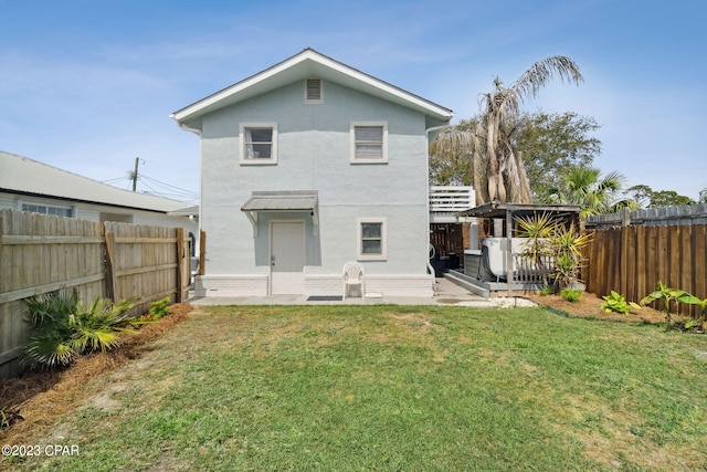 rear view of property with a lawn