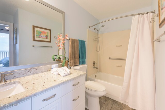 full bathroom featuring shower / bath combo, vanity, and toilet