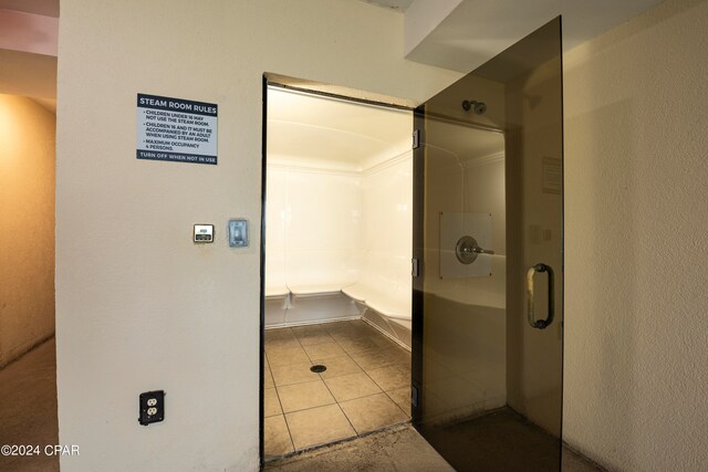 bathroom featuring a shower with shower door and tile patterned floors