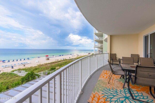 balcony with a water view and a beach view