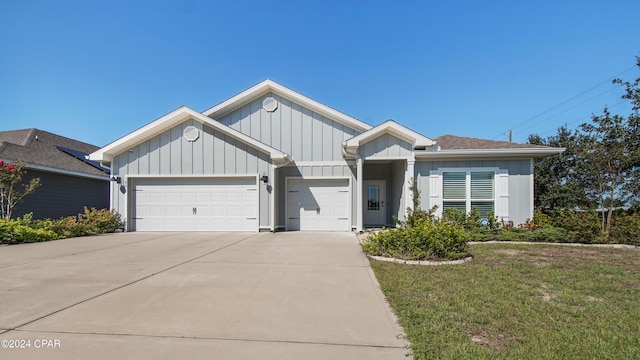 view of front of house with a front yard and a garage