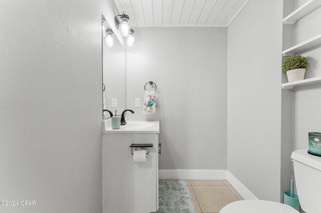 bathroom featuring tile patterned flooring, toilet, and sink