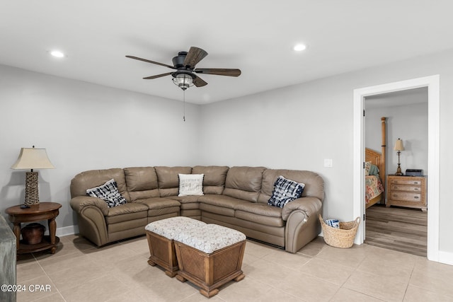 living room with ceiling fan and light tile patterned floors