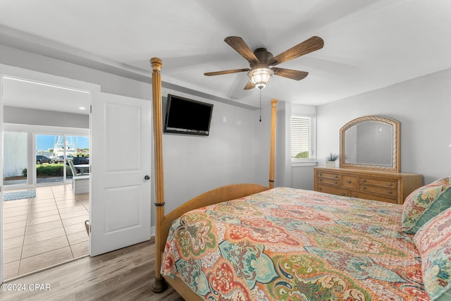 bedroom with wood-type flooring, ceiling fan, and access to outside