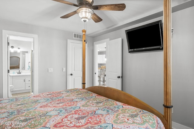 bedroom featuring ensuite bath, ceiling fan, and sink