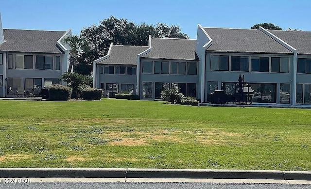 rear view of house with a yard