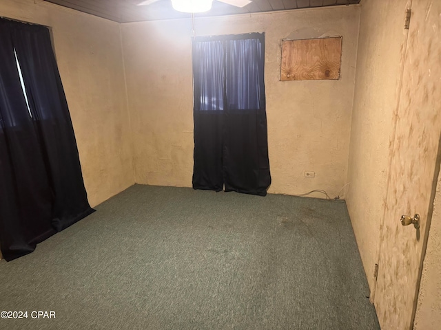 unfurnished room with ceiling fan and carpet flooring