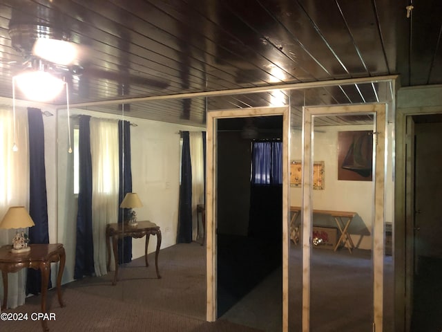 basement with carpet flooring and wooden ceiling