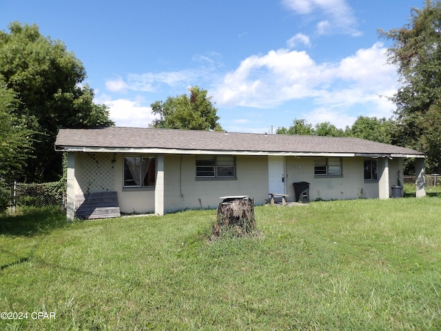 rear view of property with a yard