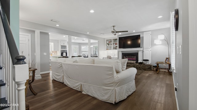 living room featuring ceiling fan and hardwood / wood-style flooring