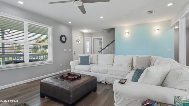 living room with ceiling fan and dark hardwood / wood-style flooring