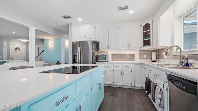 kitchen with dark wood-type flooring, sink, white cabinetry, decorative backsplash, and appliances with stainless steel finishes