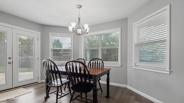 dining room with a chandelier and dark wood-type flooring