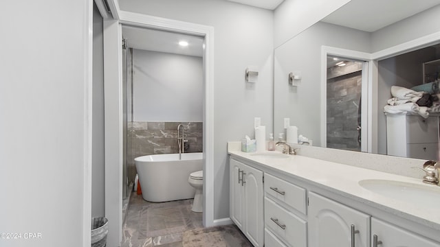 bathroom with tile walls, a bathing tub, toilet, and vanity