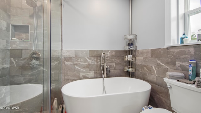 bathroom with independent shower and bath, tile walls, and toilet