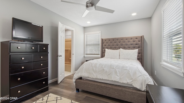 bedroom with connected bathroom, ceiling fan, and dark hardwood / wood-style floors