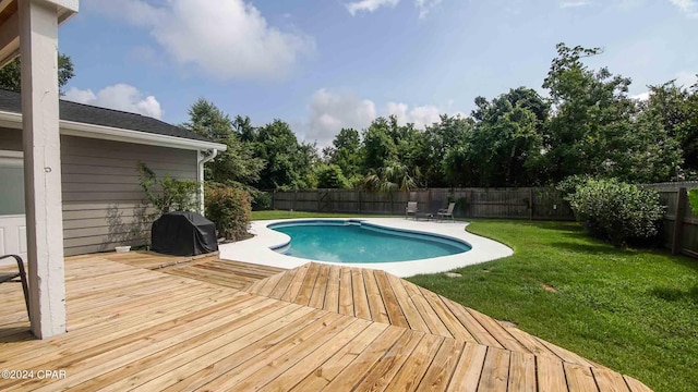 view of swimming pool with a lawn and a grill