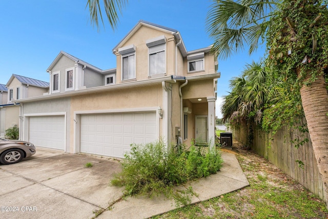 multi unit property featuring central AC unit and a garage