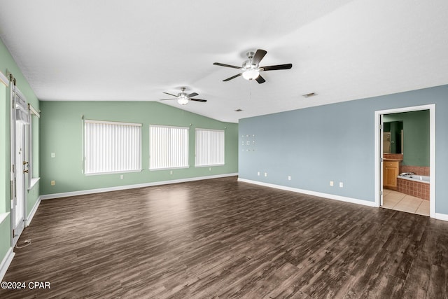 spare room with ceiling fan, hardwood / wood-style flooring, and vaulted ceiling