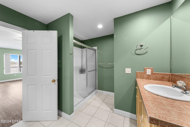 bathroom featuring walk in shower, vanity, and tile patterned floors