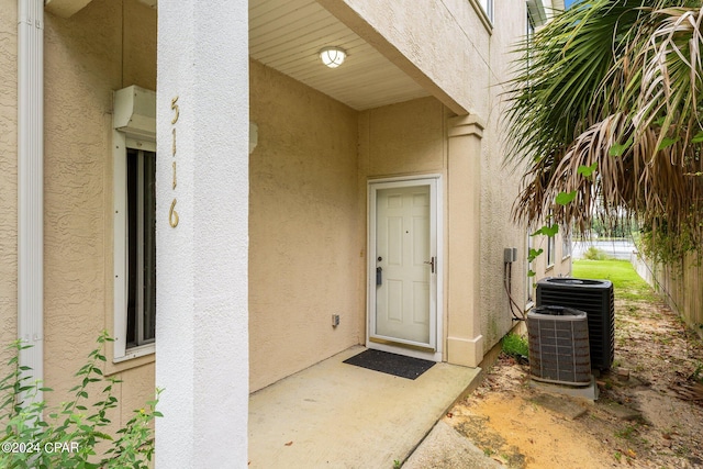 doorway to property featuring cooling unit