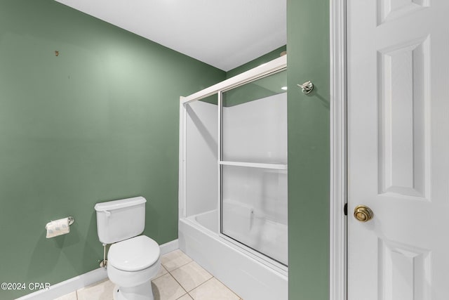 bathroom featuring bath / shower combo with glass door, toilet, and tile patterned floors