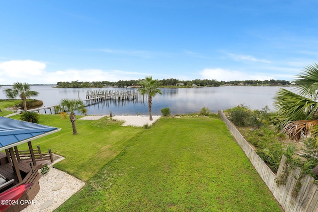 deck with a lawn and a water view