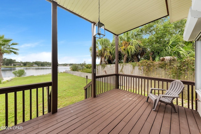 deck featuring a water view and a yard