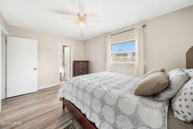 bedroom with ensuite bath, ceiling fan, and light wood-type flooring