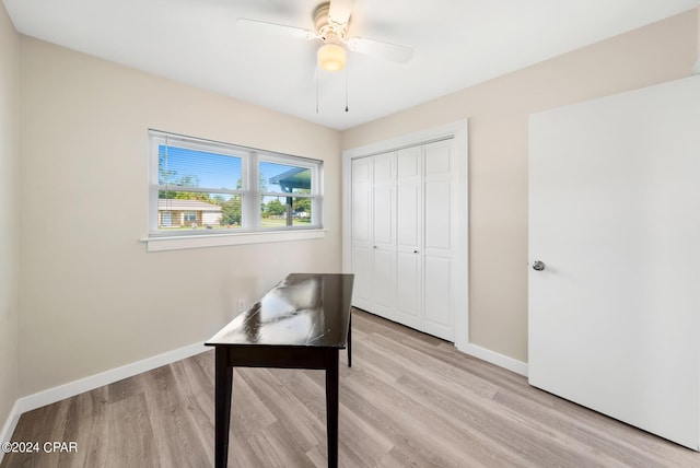 home office with ceiling fan and light hardwood / wood-style flooring