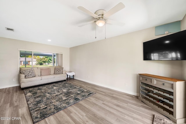 living room with ceiling fan and light hardwood / wood-style floors