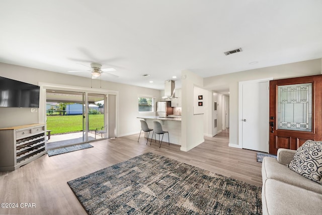 living room with light wood-type flooring and ceiling fan