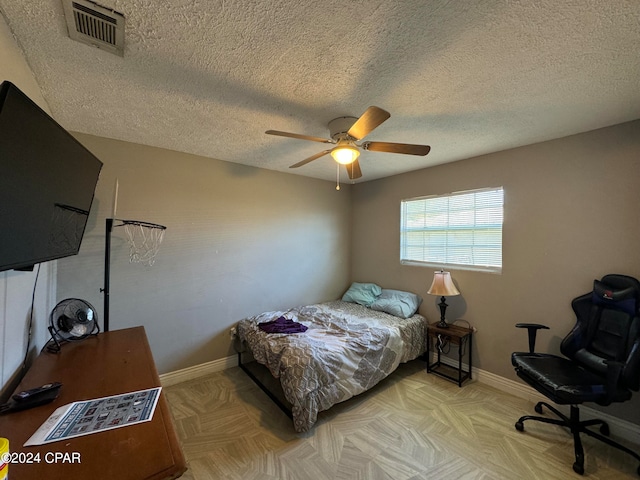 bedroom with a textured ceiling and ceiling fan