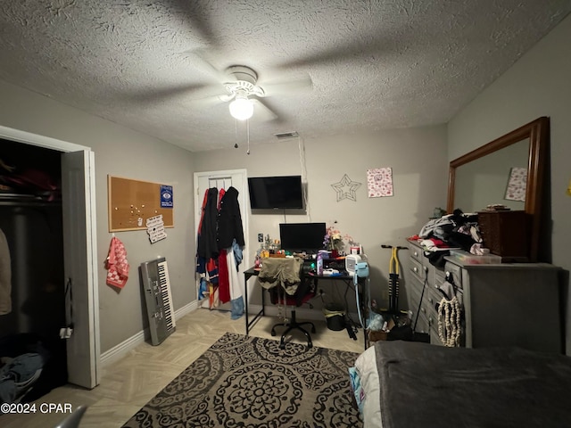 office area with a textured ceiling, light parquet flooring, ceiling fan, and heating unit