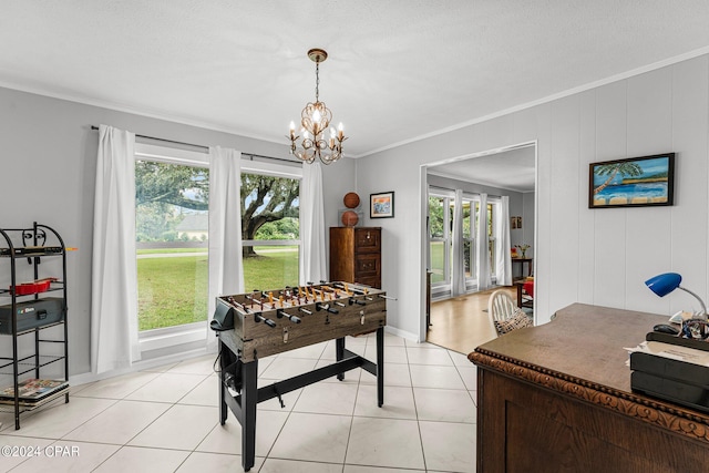 recreation room with a chandelier, plenty of natural light, light tile patterned flooring, and crown molding