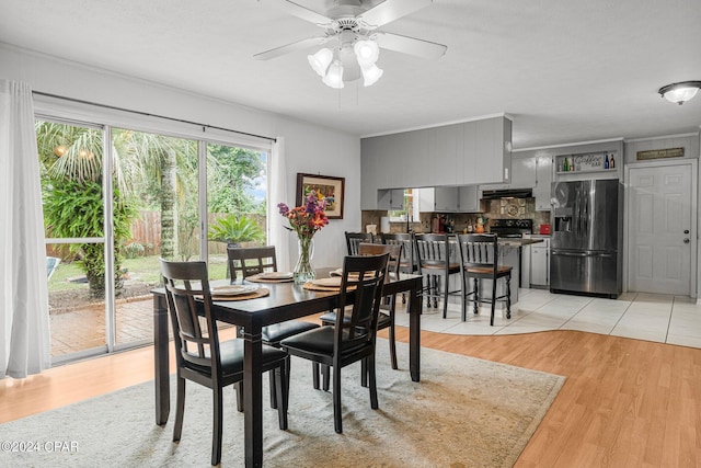 dining area with ceiling fan and light hardwood / wood-style flooring