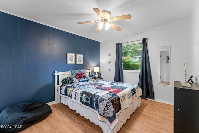 bedroom with ceiling fan, light hardwood / wood-style flooring, and ornamental molding