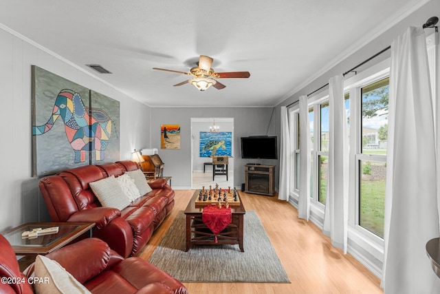 living room with ornamental molding, hardwood / wood-style floors, and ceiling fan